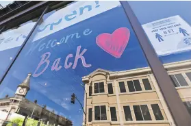  ?? Josh Edelson / Special to The Chronicle ?? A message posted on a Starbucks window in Napa recently. Some restaurant­s there have begun to fully reopen while nearby counties remain more cautious.