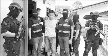  ??  ?? Officers from the Bukit Aman Counter Terrorism special unit detaining a suspected militant on Dec 22. — Bernama photo