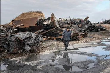  ?? ANDREW KRAVCHENKO / ASSOCIATED PRESS ?? A worker walks at a fuel depot hit by a Russian missile in the town of Kalynivka, near Kyiv, Ukraine, on Oct. 27.