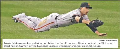  ?? CHARLIE NEIBERGALL/AP ?? Travis Ishikawa makes a diving catch for the San Francisco Giants against the St. Louis Cardinals in Game 1 of the National League Championsh­ip Series, in St. Louis.