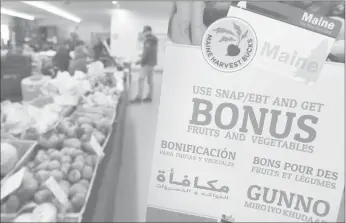  ??  ?? A sign advertises a program that allows food stamp recipients to use their EBT cards to shop at a farmer’s market in Topsham, Maine, on March 17.