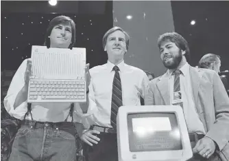  ?? SAL VEDER/ASSOCIATED PRESS ?? Steve Jobs, left, chairman of Apple; John Sculley, president and CEO; and Steve Wozniak, right, co-founder of Apple, unveil an Apple IIc computer in San Francisco in 1984.