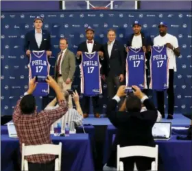  ?? MATT SLOCUM — THE ASSOCIATED PRESS ?? Philadelph­ia 76ers’ draft picks Anzejs Pasecniks, from left, managing owner Josh Harris, Markelle Fultz, team president Bryan Colangelo, Jonah Bolden and Mathias Lessort pose after a news conference at the team’s NBA basketball training complex Friday...