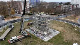 ?? STEVE HELBER — THE ASSOCIATED PRESS ?? Workers begin the disassembl­y of the pedestal that once held the statue of Confederat­e General Robert E. Lee on Monument Avenue, Dec 8, in Richmond, Va.
