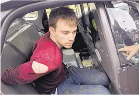  ?? METRO NASHVILLE POLICE DEPARTMENT/ASSOCIATED PRESS ?? Travis Reinking sits in a police car after being arrested in Nashville, Tenn., Monday. Police said Reinking opened fire at a Waffle House Sunday, killing at least four people.