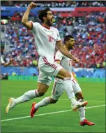  ?? REUTERS ?? LATE WINNER: Iran’s Karim Ansarifard and Mehdi Taremi celebrate their team’s goal