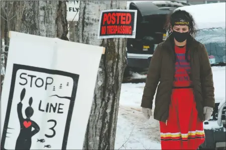  ??  ?? Taysha Martineau of the Fond du Lac tribe of Ojibwe at Camp Migizi stands on land she helped purchase near an Enbridge Line 3 constructi­on site in Cloquet, Minn.