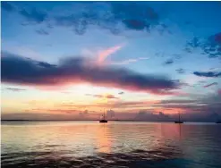  ??  ?? Photos shows a colorful sunset viewed from the Caribbean Club at Key Largo, Florida.