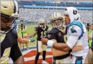  ?? BOB LEVERONE — THE ASSOCIATED PRESS FILE ?? Panthers quarterbac­k Cam Newton (1) and Saints quarterbac­k Drew Brees (9) embrace before a game earlier this season. Saints coach Sean Payton takes a small measure of comfort in New Orleans’ regular-season sweep of Carolina. It means the Saints play...