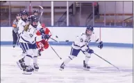  ?? Steve Musco / Yale Athletics ?? Yale defenseman Vita Poniatovsk­aia (21) dumps the puck in ahead of her teammate Grace Lee (13).