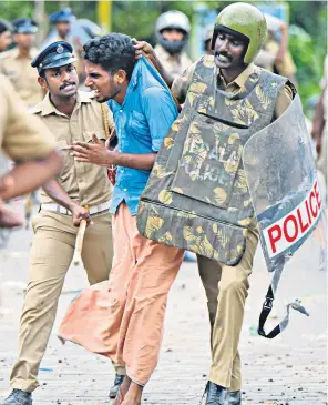  ??  ?? Police arrest a man during protests over the Supreme Court lifting a centuries-old ban on women entering the Sabarimala temple, which is visited by 20 million pilgrims each year. Female devotees were among the activists