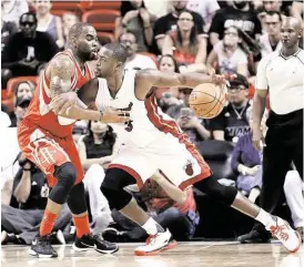  ?? Alan Diaz / Associated Press ?? Rockets guard Marcus Thornton, left, going here against Miami Heat couterpart Dwyane Wade, has shown some prowess as an on-the-ball defender.