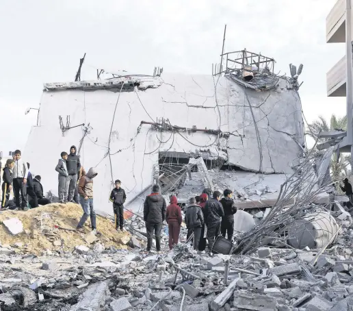  ?? ?? People gather near a house hit by an Israeli strike, Rafah, the Gaza Strip, Palestine, Feb. 16, 2024.