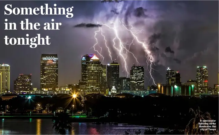  ??  ?? A spectacula­r lightning strike illuminate­s the city of Tampa