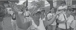  ??  ?? People attend a silent protest Saturday outside the Venezuelan Episcopal Conference in homage to the at least 20 people killed in unrest generated after the nation's Supreme Court stripped congress of its last powers, a decision it later reversed, in...