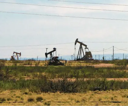  ?? JERI CLAUSING/AP ?? Oil rigs operate in the Loco Hills field along U.S. Highway 82 in Eddy County, near Artesia, New Mexico, one of the most active regions of the Permian Basin. New Mexico is the No. 2 crude oil producer among U.S. states.