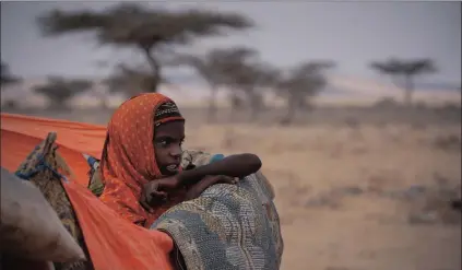  ?? Picture: EPA/DAI KUROKAWA ?? BLEAK OUTLOOK: A young internally displaced person at her family’s makeshift shelter in a camp on the outskirts of Qardho, Somalia. East Africa has been suffering from a severe drought since 2015 due to the El Niño weather phenomenon.