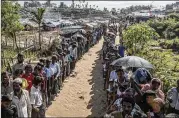  ?? BLOOMBERG ?? Rohingya peoplewait in line for supplies at a refugee camp in Bangladesh on Sept. 21, 2017. Some 700,000 Rohingya fled theirhomes for neighborin­g Bangladesh after a brutal military campaign last year.