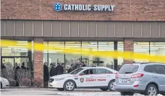 ?? AP ?? Authoritie­s investigat­e the scene at a Catholic Supply store where a gunman sexually assaulted at least one woman and shot a woman in the head on Monday.