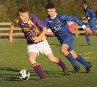  ??  ?? Stephen Kearns of the Wexford Football League is chased by Waterford’s Luke Kervick.