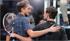  ?? FRANK AUGSTEIN/AP PHOTO ?? Russia’s Daniil Medvedev, left puts his arm around Austria’s Dominic Thiem after winning Sunday’s ATP World Finals in London.