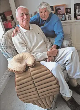  ?? STAFF PHOTO BY MATT STONE (ABOVE); COURTESY PHOTOS ?? HONORING THE FALLEN: Walter Greeley of Wellesley, with his wife Ali, display the catcher’s mitt and pads of his uncle, Robert Hewins Stiles, from his 1916 season at Harvard. Stiles (inset) was shot down in World War I in the French village of Pournoy-La-Chetive in 1918, and was buried in an American cemetery in France.