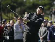  ?? ASSOCIATED PRESS ?? IN POSITION: Leader Phil Mickelson watches his tee shot at the fourth hole during yesterday’s weatherdel­ayed final round of the Pebble Beach Pro-Am.