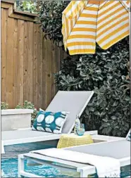  ?? HEATHER HAWKINS/ABBE FENIMORE ?? Throw pillows and poolside tables can bring a bit of vacation resort experience to a backyard pool.
