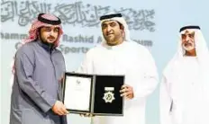  ?? Ahmed Ramzan/ Gulf News ?? Fitting tribute Shaikh Nahyan and Shaikh Ahmad present Her HIghness Shaikha Fatima Bint Mubarak’s award to Shaikh Mohammad Bin Hamdan Bin Zayed Al Nahyan in her absence.