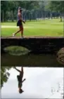  ?? BUTCH DILL — THE ASSOCIATED PRESS ?? Michelle Wie walks across a bridge from the sixth green during the second round of the U. S. Women’s Open at Shoal Creek, Friday in Birmingham, Ala.