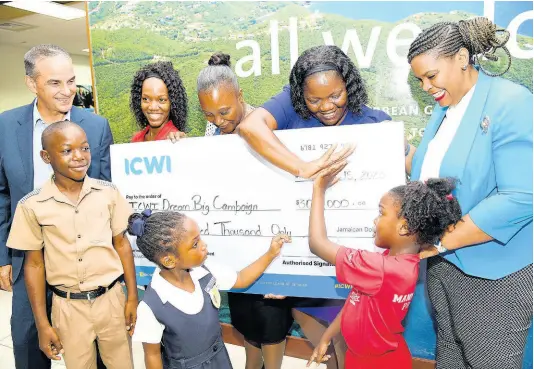  ?? RUDOLPH BROWN/PHOTOGRAPH­ER ?? Paul Lalor (left), president of the Insurance Company of the West Indies (ICWI), smiles while observing the interactio­n between a student and teacher during the cheque handover to teachers Kadine Fisher (second left, back) of Mannings Hill Primary, Sanika Roberts (centre, back), of St Catherine Primary, and Mecalea Powell (second right), of Russells Primary and Infant School, while Jamaica Teachers’ Associatio­n President, La Sonja Harrison (right) looks on. Students participat­ing in the exercise are Deandre Simpson (left, front) of Russells Primary and Infant School; Sarah-Kay Campbell (centre, front) of St Catherine Primary, and Kelecia Calame of Mannings Hill Primary. The ICWI Dream Big Teachers’ Day awards presentati­on took place at ICWI’s head office on St Lucia Ave in New Kingston on Monday.