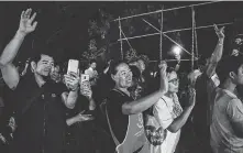  ?? Lauren DeCicca / Getty Images ?? Onlookers cheer as ambulances transport rescued boys to a hospital on Monday in Chiang Rai, Thailand. At the hospital, the boys are being kept in isolation over infection fears.