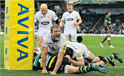  ??  ?? Pile-up: Wasps captain Joe Launchbury celebrates as Juan de Jongh scores his side’s fourth try at Franklin’s Gardens