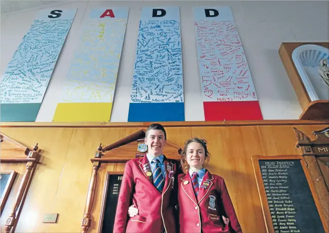  ?? Photo: NATASHA THYNE/FAIRFAX NZ ?? Doing well: Roncalli College wellbeing leaders Lachie Scarsbrook and Sophie Newmarch in front of the SADD (Students Against Dangerous Driving) pledge boards the whole school signed.