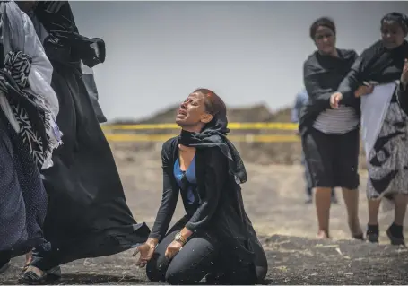  ?? AP ?? Relatives of crash victims grieve at the site where the Ethiopian Airlines Boeing 737 Max 8 crashed shortly after take-off on Sunday. The aircraft model has been grounded worldwide amid fears of a recurring technical problem