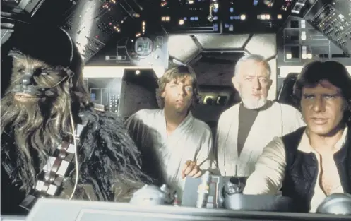  ??  ?? 0 Peter Mayhew as Chewbacca with Mark Hamill, Alec Guinness and Harrison Ford in Star Wars