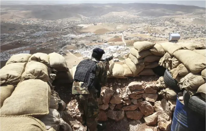  ??  ?? ARSAL: In this June 19, 2016 file photo, a Lebanese army soldier takes his position overlookin­g an area controlled by the Islamic State group at the edge of the town of Arsal, in northeast Lebanon. — AP