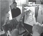  ?? SEALS/DETROIT FREE PRESS
ERIC ?? Caricature artist Bob Anderson of Pleasant Ridge draws Zarek Ludeman, 17, of Warren, during the 2020 edition of Shiver on the River at the Belle Isle Casino in Detroit.