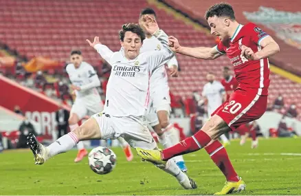  ?? AFP ?? Liverpool’s Diogo Jota, right, shoots wide during the Champions League quarterfin­al second leg match against Real Madrid at Anfield.