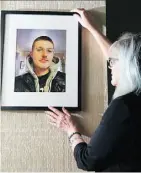  ?? GERRY KAHRMANN ?? Kat Wahamaa hangs up a photo of her son Joseph Taylor-Wahamaa, who died at 25.
