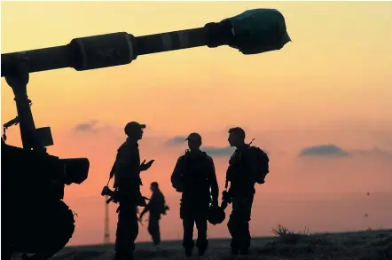  ?? GETTY IMAGES ?? Israeli soldiers prepare their artillery near the border with the Gaza Strip yesterday. The latest outbreak of fighting between militants in the Gaza Strip and the Israeli military has killed at least 139 people in Gaza, and seven Israelis. The violence has also spilled over into the West Bank, where Israeli troops shot at least 11 protesters dead yesterday.