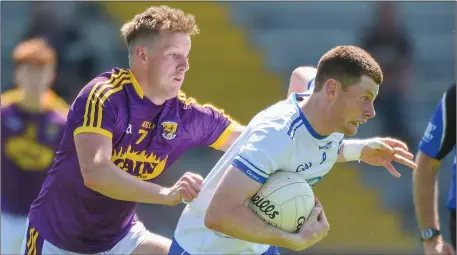  ??  ?? Wexford’s Tiarnan Rossiter tries to halt the run of Michael Curry (Waterford).