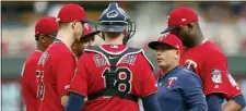  ?? JIM MONE — THE ASSOCIATED PRESS ?? Twins pitching coach Wes Johnson, right, holds a meeting on the mound with pitcher Taylor Rogers, left, and catcher Mitch Garver during a game in August.