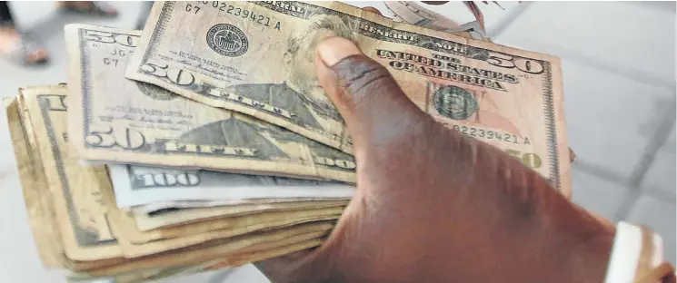  ?? Picture: Reuters ?? The US dollar is in huge demand in Zimbabwe as businesses and people demand payment in favour of the greenback ahead of bond notes, bank transfer and payment by local bank cards.
