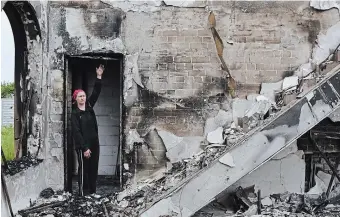  ?? ANDRIY ANDRIYENKO THE ASSOCIATED PRESS ?? Valentina, 53, a local woman, stands inside of Evangelica­l Christian Baptists prayer house which was destroyed Sunday by a Russian attack in Orihiv, Ukraine, on Monday.