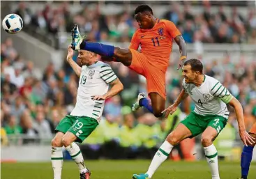  ??  ?? High-risk attempt: Holland’s Quincy Promes making a clearance as Ireland’s John O’Shea (right) looks on in the friendly in Dublin on Friday. — Reuters