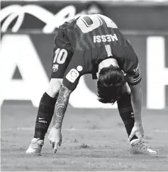  ?? - AFP Photo ?? At a stretch: Lionel Messi on Sunday as Barcelona were held 1-1 at Valencia.