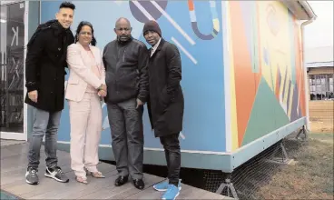  ?? PICTURE: THEO GARRUN ?? POWER IN PARTNERSHI­P: Gail Walters (second, left)
and Sifiso Ntshangase (second, right) with Danny K and Kabelo Mabelane outside a school library for which they
raised funds.