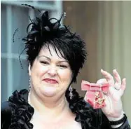  ??  ?? Gocompare.com chief executive Hayley Parsons shows off her OBE insignia outside the palace