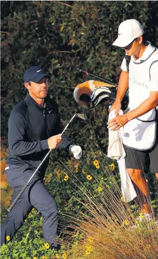  ??  ?? Going undergroun­d: Rory Mcilroy finds trouble on his opening hole at TPC Sawgrass